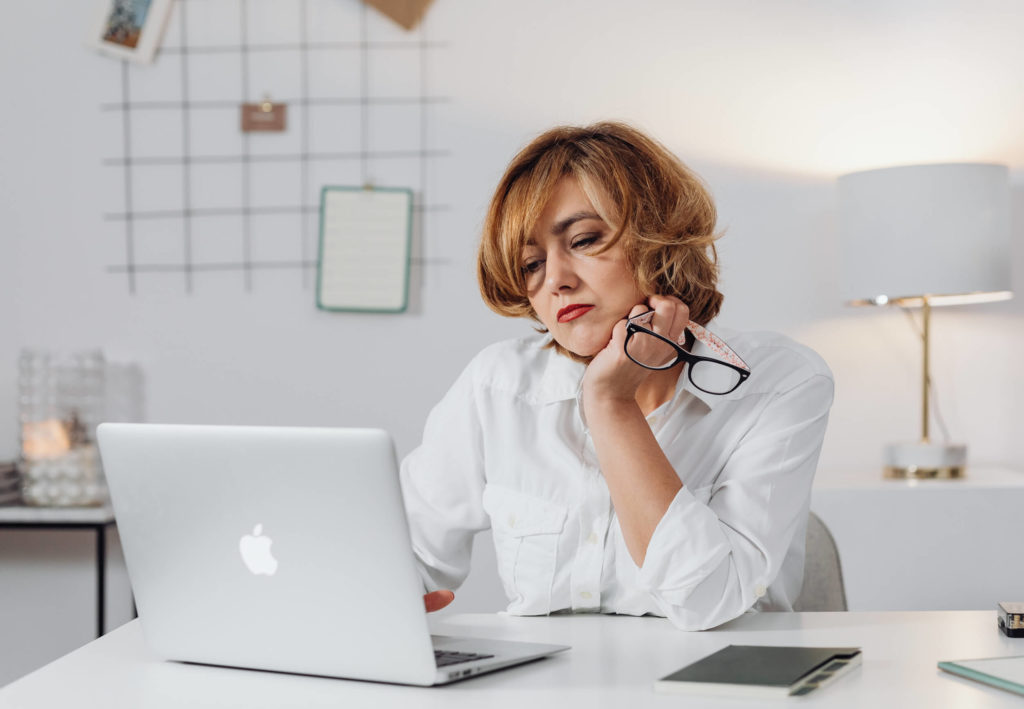 defeated dentist looking at laptop