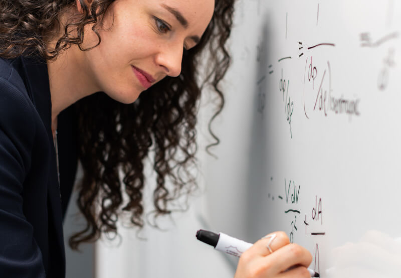 dentist writing formula on white board